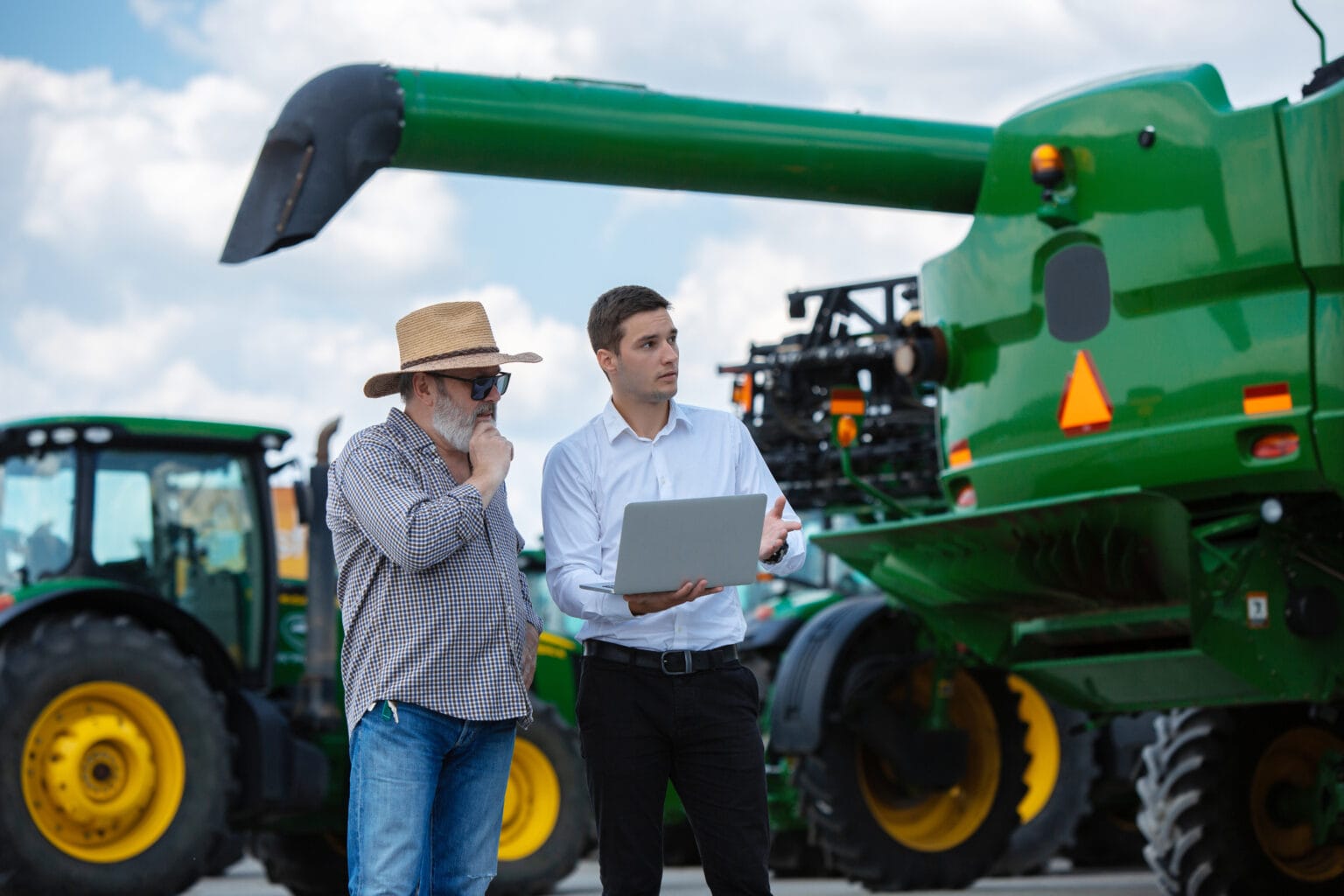 A farmer with a tractor, combine at a field in sunlight. Confident, bright colors
